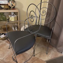 two metal swirl back chairs   $200 For The Pair