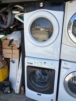 White LG ThinQ front-load dryer stacked on top of a white Maytag front-load washer. Both units are front-loading with circular glass doors. Sold as a 
