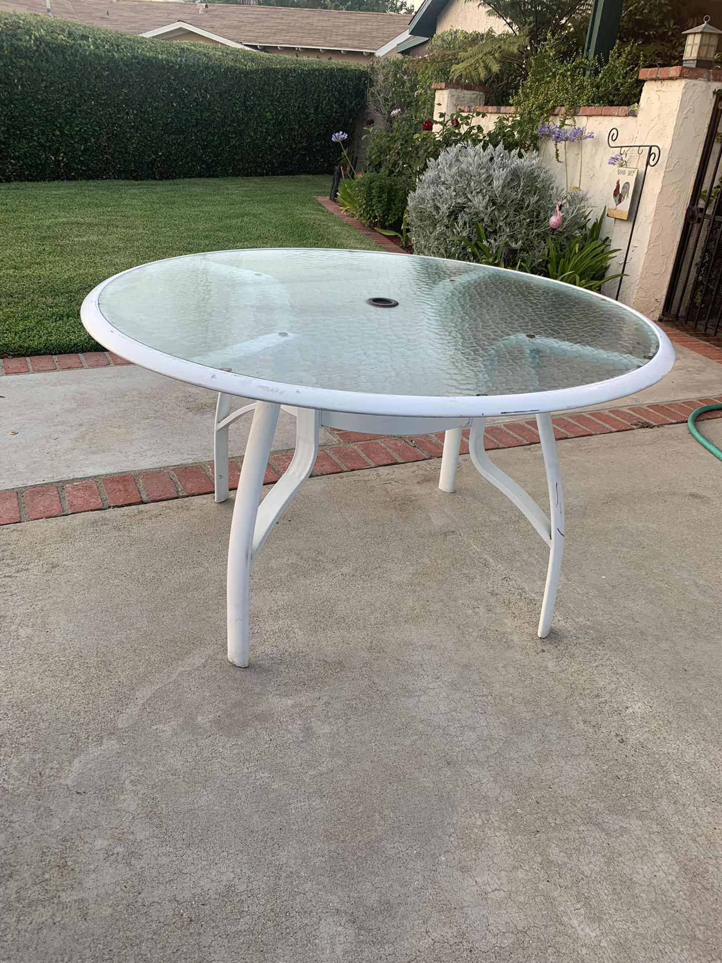 Round Metal glass top patio table.