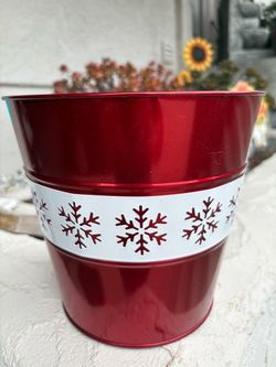red and white metal holiday planter bucket