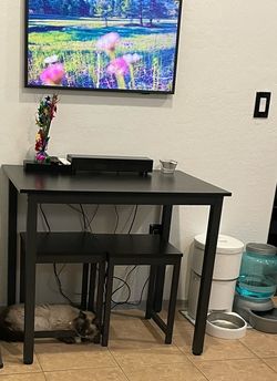 Small black dining table set for two