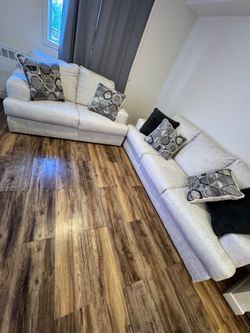 Cream colored love seat and sofa set