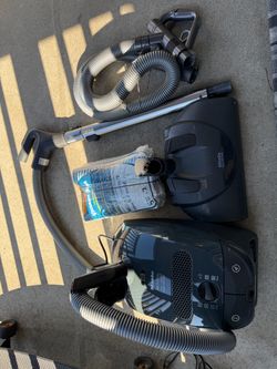 Powerful Miele S2 HomeCare canister vacuum is a dark gray corded unit made in Germany. It has a W motor and includes a telescopic stainless st