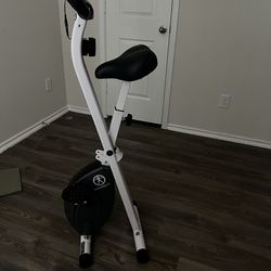 White an black Macy exercise bike