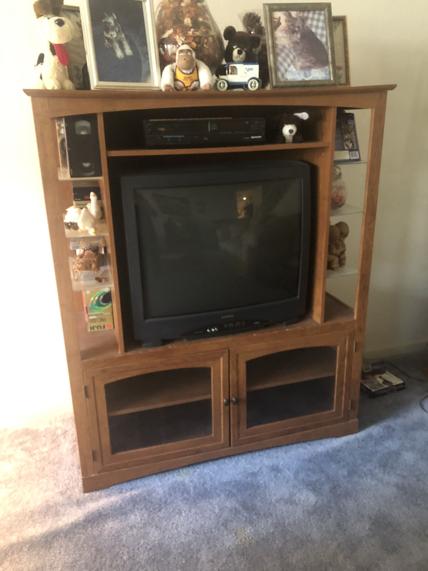 Tv entertainment center. Nice. Good condition. With glass shelves on the side. Items on stand not included. $40