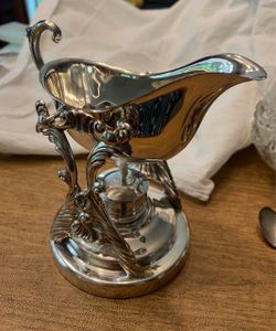 Vintage ornate silver-plate tilting gravy boat with warming stand