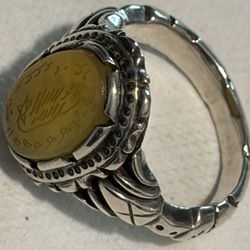 Yellow Agate (also known as Yellow Aqeeq) gemstone set in an intricately detailed 925 sterling silver band. The stone is hand-engraved with Islamic sy