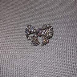 Bow brooch featuring luminescent Aurora Borealis crystals and sparkling clear crystals. 