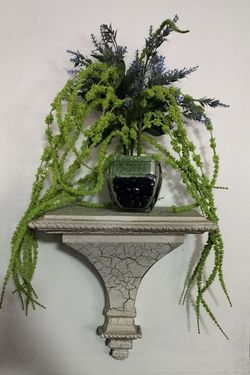 Decorative Rustic Crackled-Finish Roman style wall ledge shelf. Artificial green and blue plant arrangement in glass base with blue stones included
