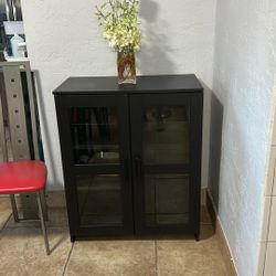 Black Bookcase With Four Shelves And Glass Doors