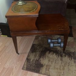Antique side table has the rolling wheels