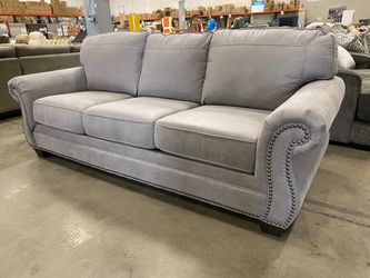 ASHLEY FURNITURE Stone Grey Suede-Like Roll Arm Sofa with Nailhead Trim