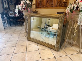 Large Elegant gold-framed mirror with intricate detailing