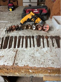 Dewalt drill,11Hole saws, and 29 paddle bits $100 in a Husky tool bag