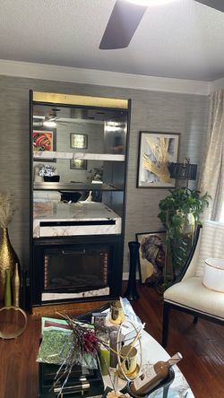 Wine or Display Case with A Fireplace below