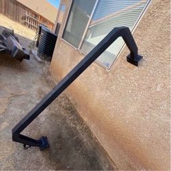 Truck bed roll back bar