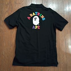 Authentic A Bathing Ape (BAPE) black polo shirt featuring the iconic Ape Head logo on the chest pocket and large multicolor “A Bathing Ape” Sz XL