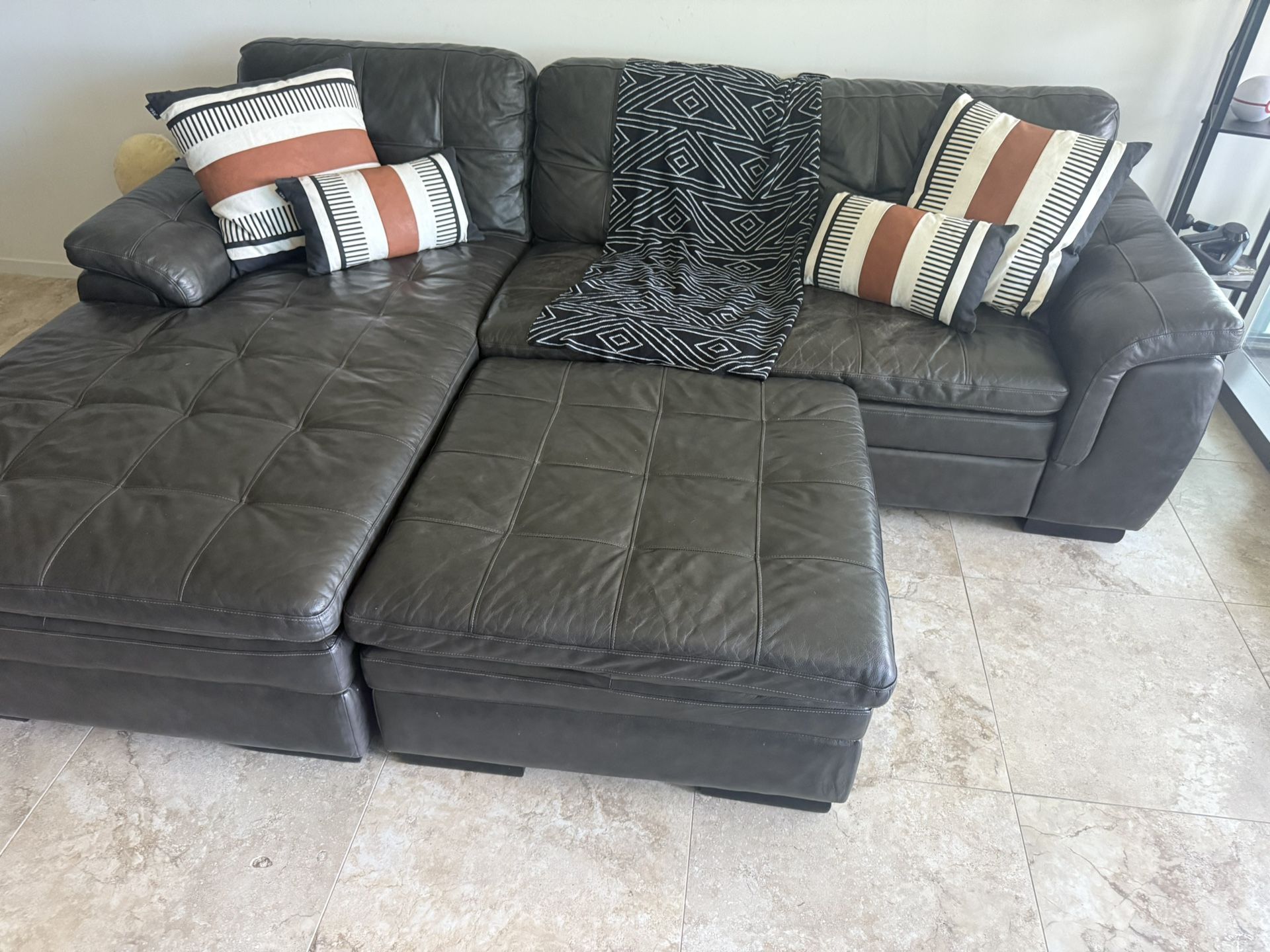 Used Black / Gray Leather Sectional Sofa with Storage Ottoman