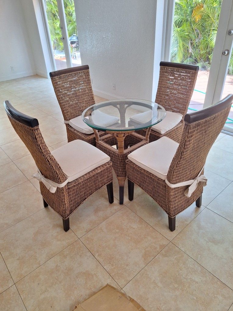 Beautiful Rattan /Mahogany Breakfast Bistro Patio Set 4 Chairs /Pads Glass Top And Matching Base excellent condition! 
As priced.... No low ballers