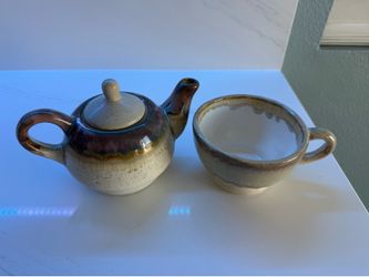 Tiny teapot with a cup