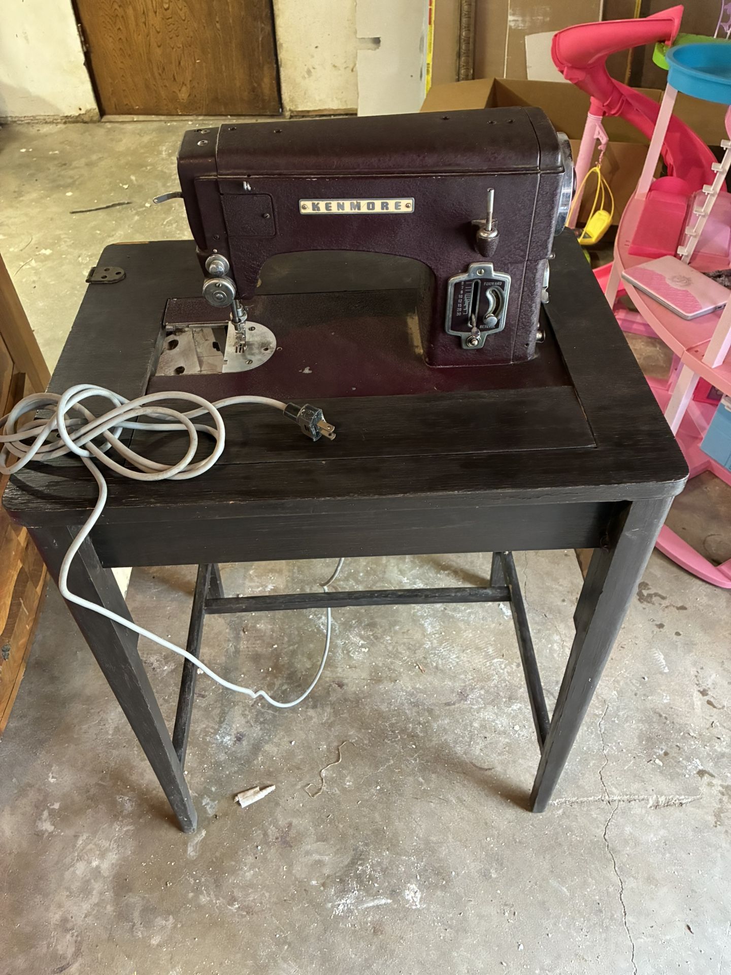 This is a vintage Kenmore sewing machine, likely from the mid-20th century, which is built into its own cabinet. Width 2ft., height 2ft. 6”.