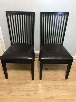 2 matching leather and wood chairs