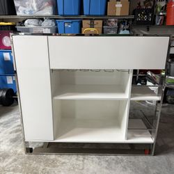 Home Decor / White Bar, Stainless Steel Frame. Dimensions: 23W x 50L x 46H Was $2,300 From City Furniture 