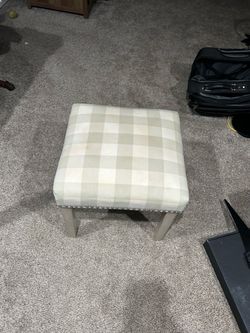 Plaid upholstered ottoman
