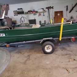 Green 14 foot  jon Boat. 15 HP Honda  Lots of extras