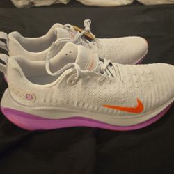 Nike InfinityRN 4 running shoes, specifically the "Vast Grey/Hyper Violet/Bright Crimson" colorway. 