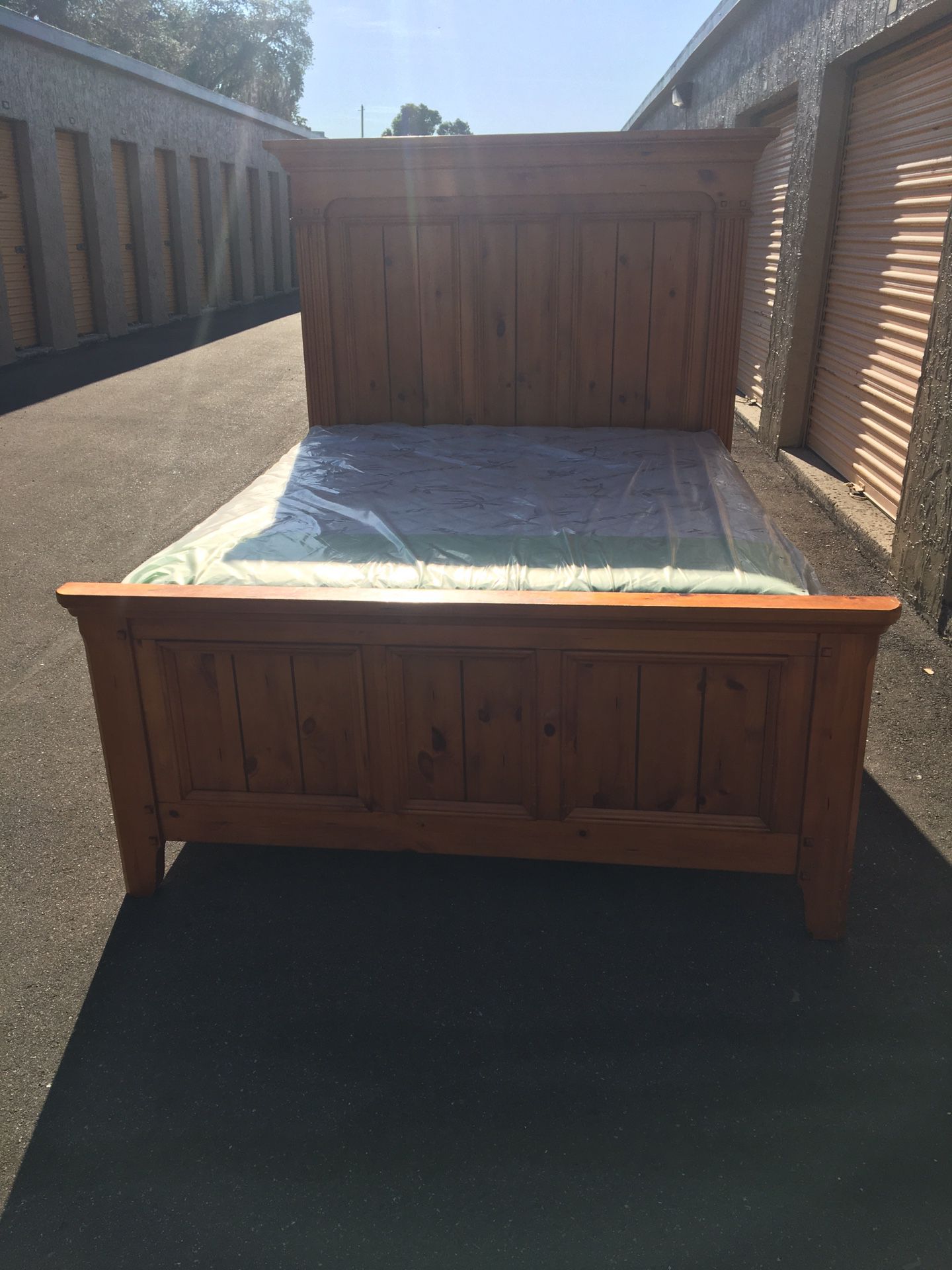 Solid wood Queen size bed frame with brand new Queen size pillows top mattress and box spring in plastics