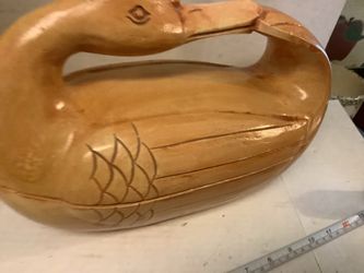 Hand-carved, light-wood duck decoy with a varnished finish, typically used as a decor, made and hand carved in the Philippines  Approximately 12” wide