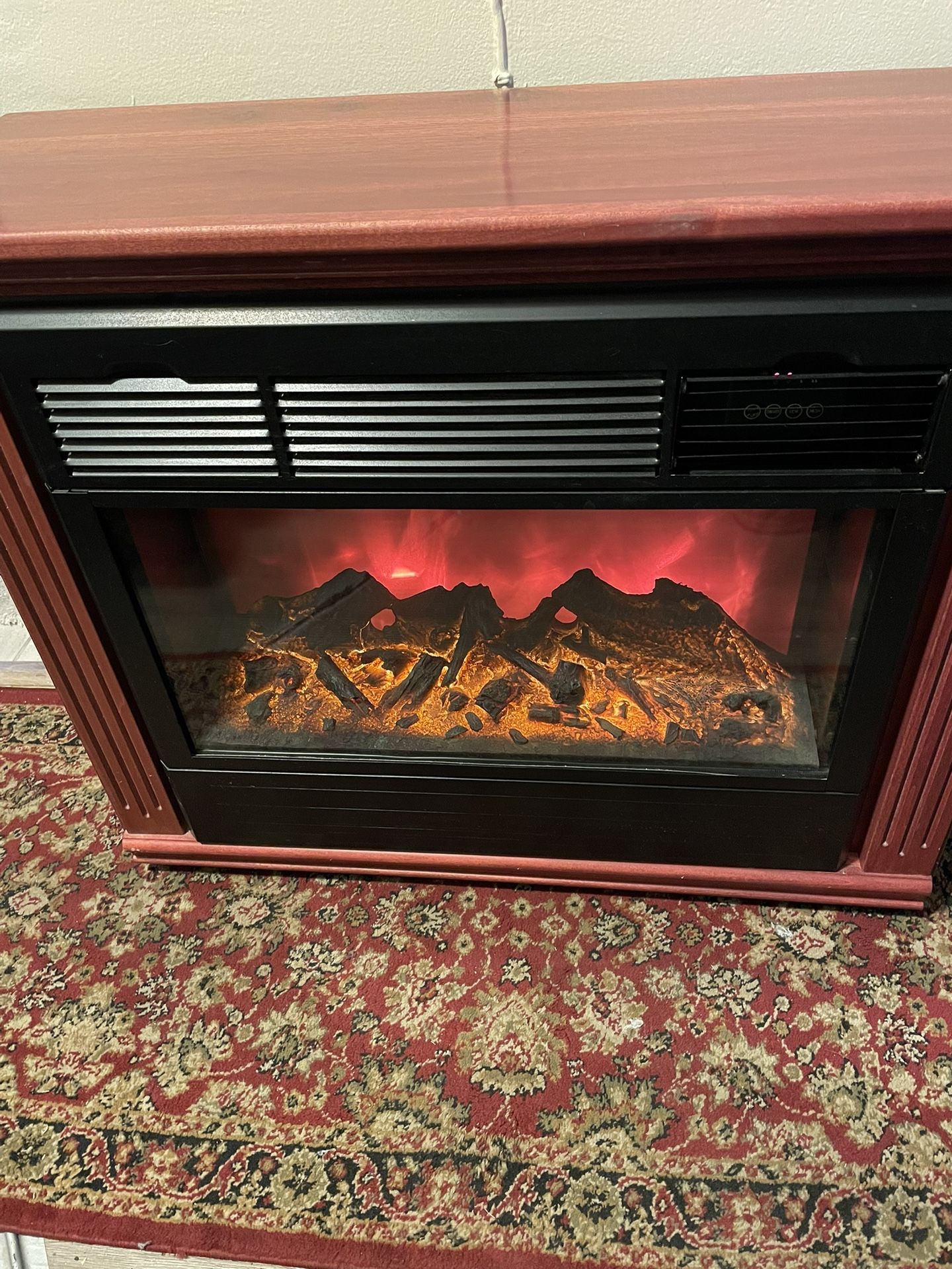 Heat Surge electric portable fireplace heater is in great condition.  Wood mantle is Amish
