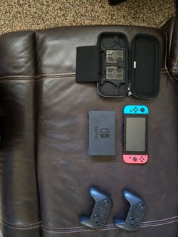 Nintendo swith with mario cart delux disc, 2 pro controllers, and case for the switch and games