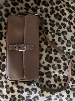 This vintage light brown leather shoulder bag is identified as a Coach Hamptons Flap Bag