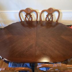 Dining room table with 2 captains chairs and 4 matching chairs also China cabinet in package