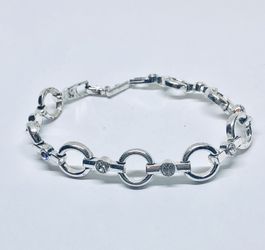 Silver tone linked bracelet with rhinestones