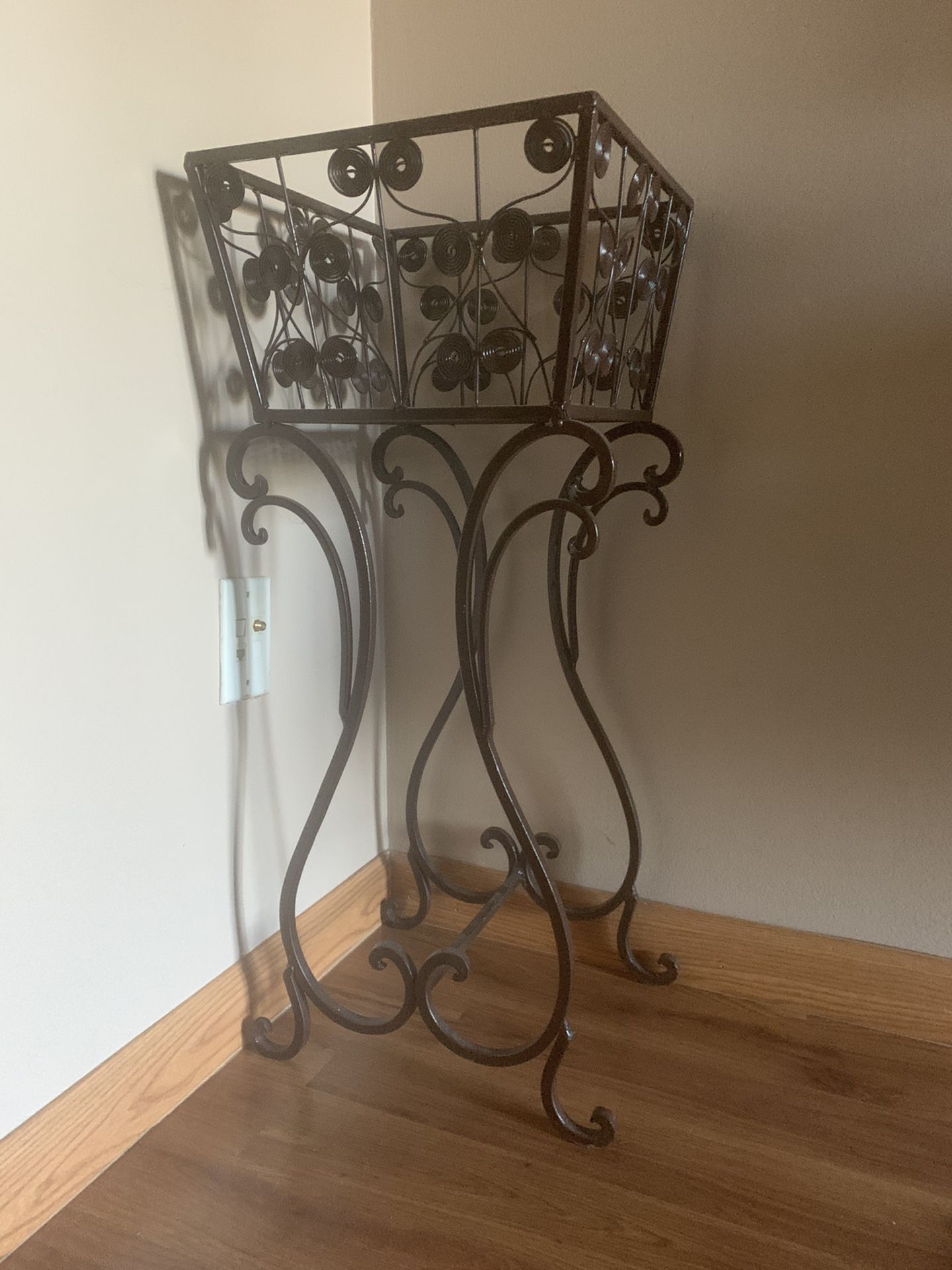 Brown metal plant stand with pot