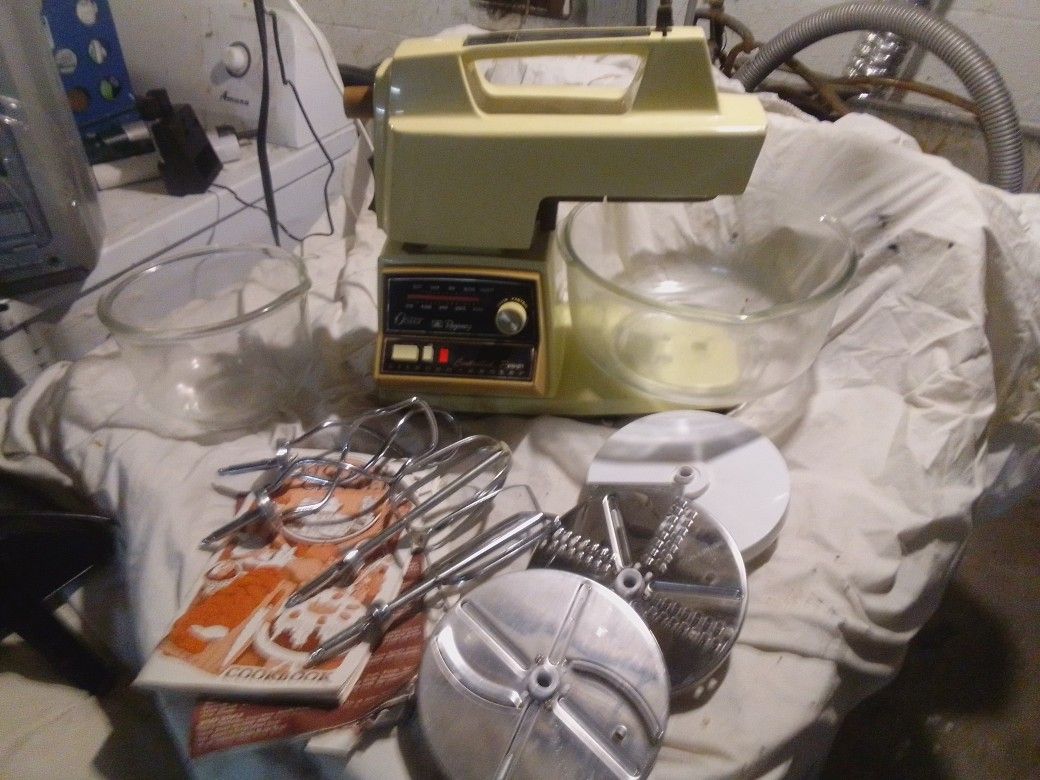 Oster Regency Kitchen Center, a vintage multi-appliance system. It includes a mixer, blender, food processor, and sometimes a grinder or juicer