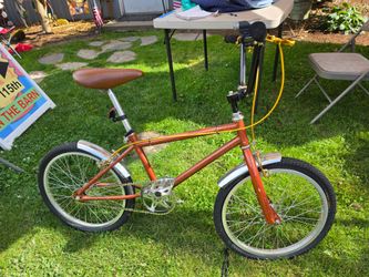 Raleigh Grifter bike from the 1970s featuring a distinct brown frame and chrome fenders.