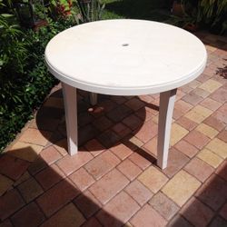 Preowned round plastic table seats four
