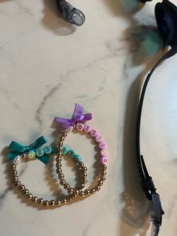 2 blue and purple besties braclets with a bow