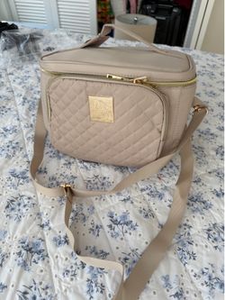 Paris Hilton tan quilted makeup bag