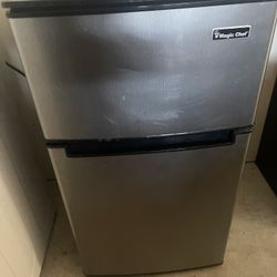 Grey, black Magic Chef mini fridge With Freezer On Top.