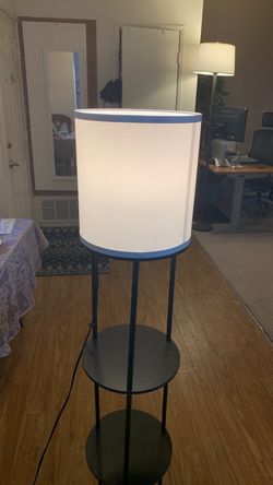 Floor lamp with lamp shade and three tier shelves