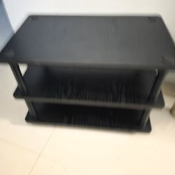 Three-tier table in black, 24 inches wide x 15 inches deep and 16 inches high.