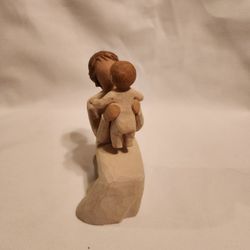 This beautiful figurine is a wonderful addition to any collection. It depicts a grandmother holding a baby and is made of resin material. The figurine