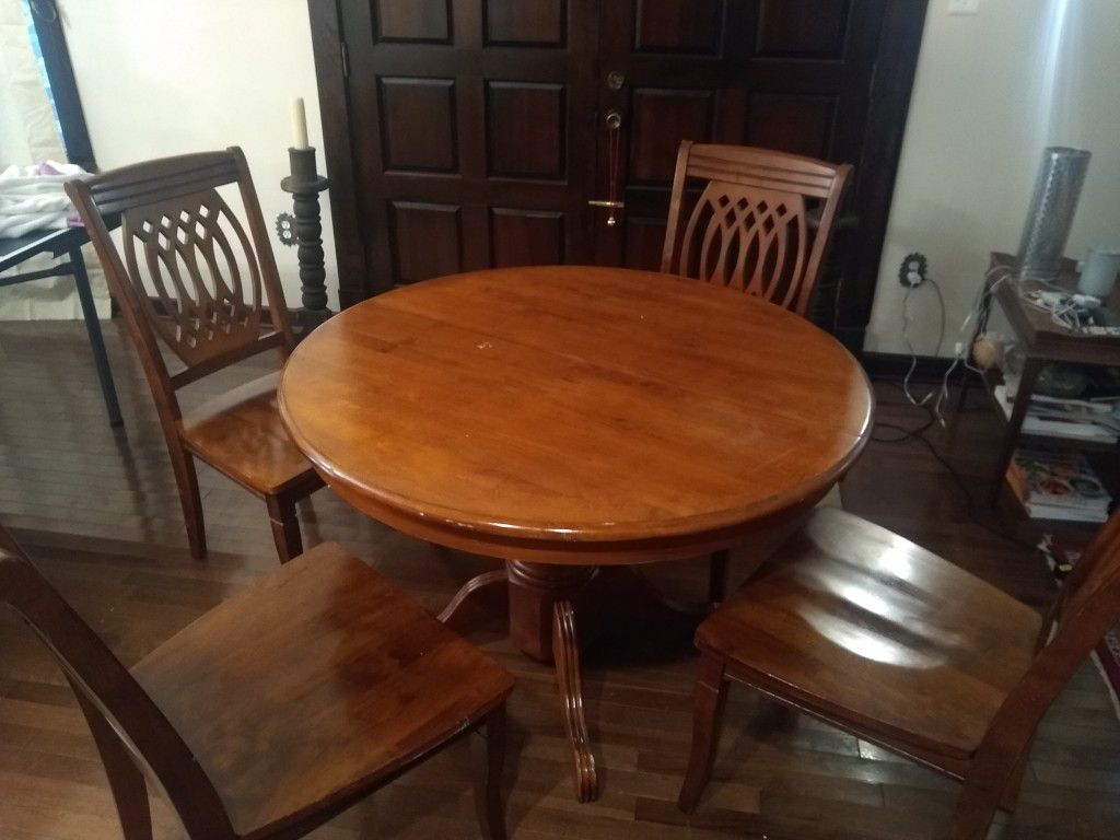 Round dining table with four chairs