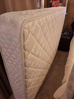 Full size mattress, box spring, & metal bed frame on wheels.