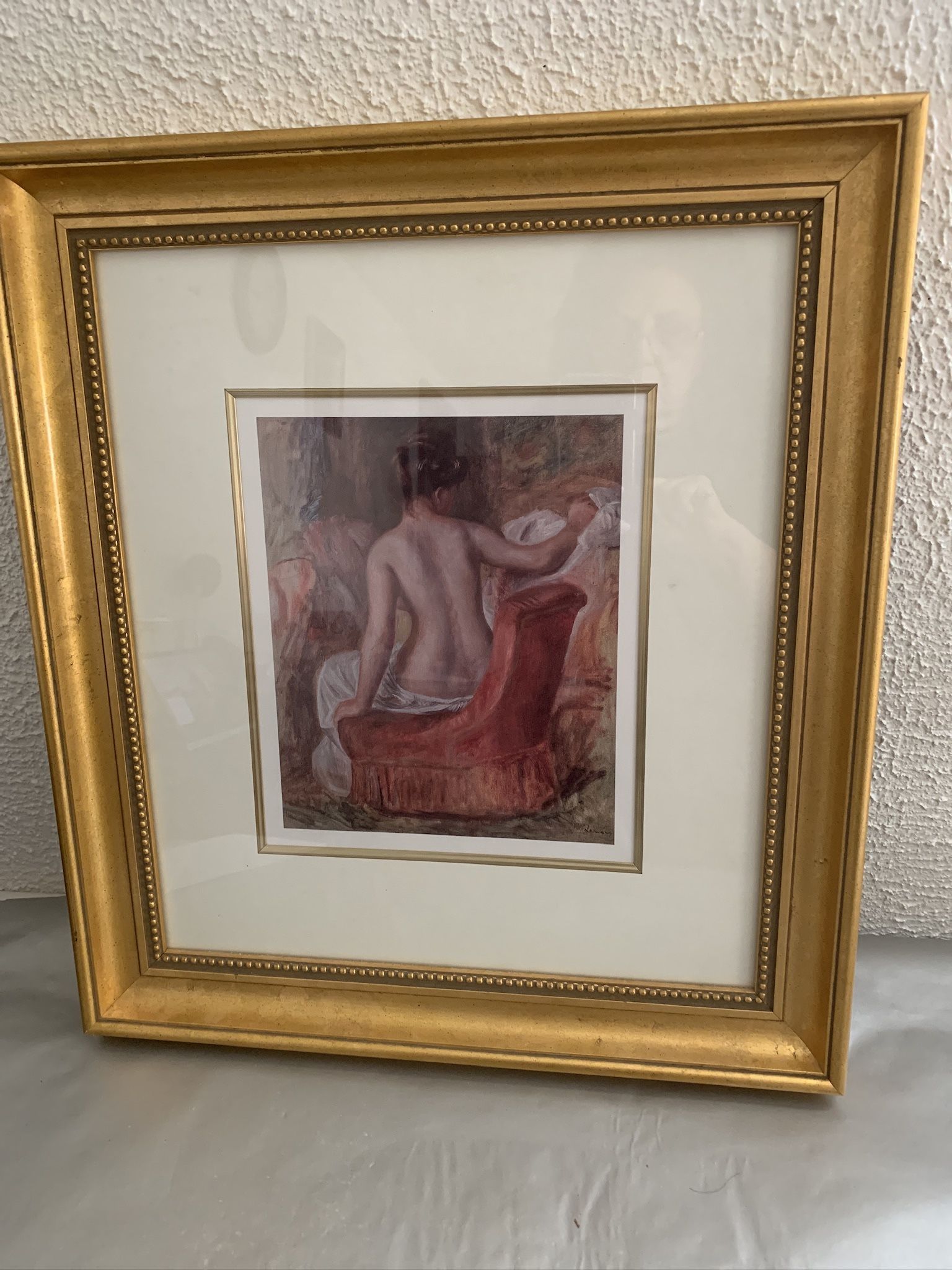 Beautiful girl seated on red sofa1876 print by Pierre Auguste Renoir in a gold frame , 17.5”x20”  Double matted The print size 8.5”x10”  Local pick up